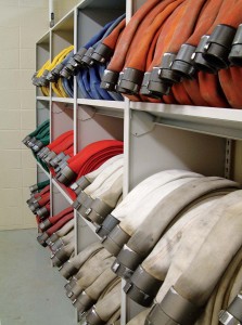 Close up angle of fire hoses stored in shelving units